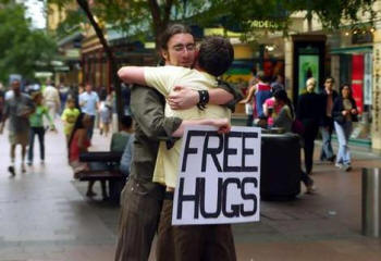 Juan Mann with placard hugging his victim